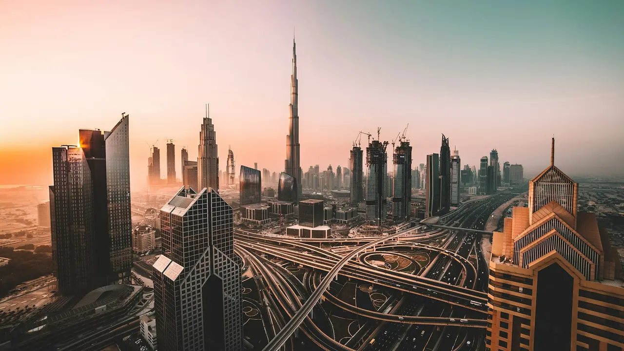The Dubai skyline with the Burj Khalifa and a highway interchange at sunrise